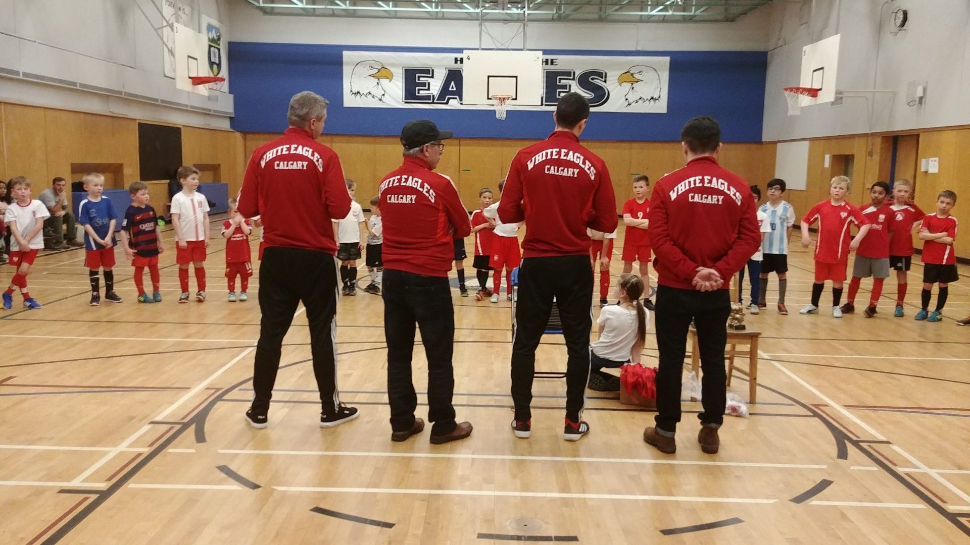 White Eagles Calgary coaches and youth players in the gym